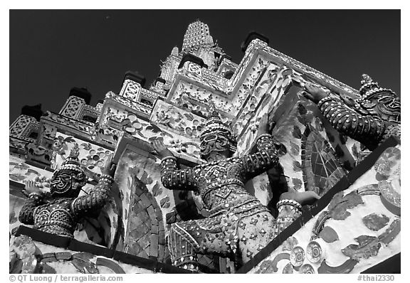 Statues at the base of the prang, Wat Arun. Bangkok, Thailand