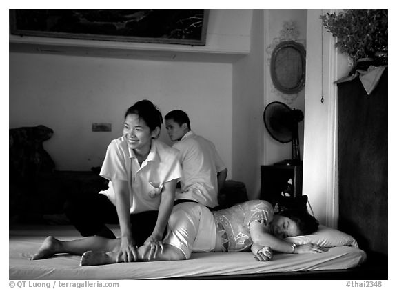 Traditional thai massage in traditional Thai medicine center of Wat Pho. Bangkok, Thailand (black and white)