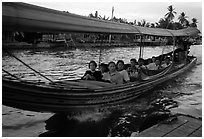 Evening commute, long tail taxi boat on canal. Bangkok, Thailand ( black and white)