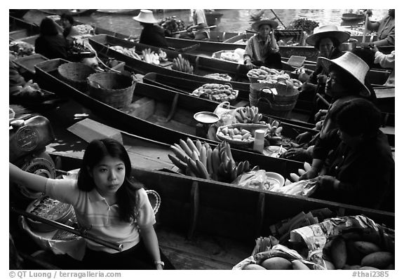 Woman on small boat, floating market. Damonoen Saduak, Thailand