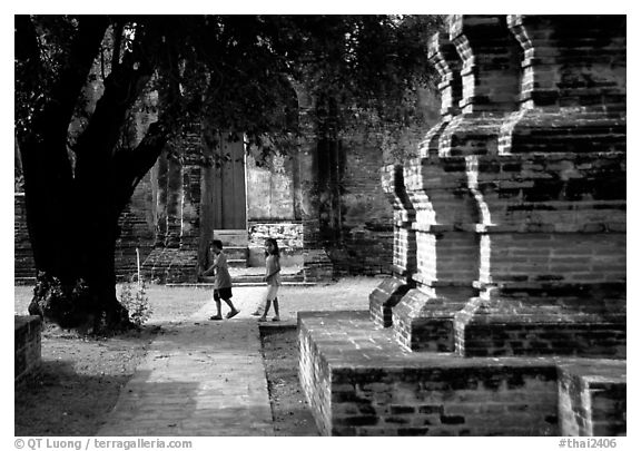 Children walk among ruins of the King Narai's palace. Lopburi, Thailand