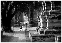 Children walk among ruins of the King Narai's palace. Lopburi, Thailand (black and white)