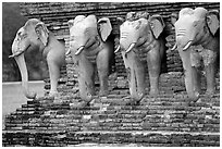 Some of the 36 elephants at the base of Wat Cahang Lom. Sukothai, Thailand (black and white)