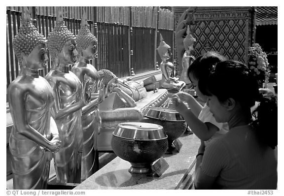 Worshiper makes offering at Wat Phra That Doi Suthep. Chiang Mai, Thailand (black and white)