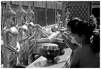 Worshiper makes offering at Wat Phra That Doi Suthep. Chiang Mai, Thailand (black and white)