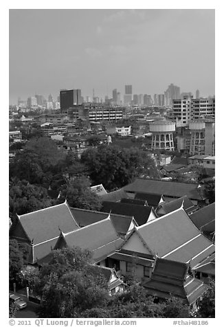 Temple rooftop and modern skyline. Bangkok, Thailand (black and white)