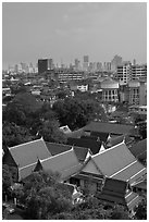Temple rooftop and modern skyline. Bangkok, Thailand (black and white)