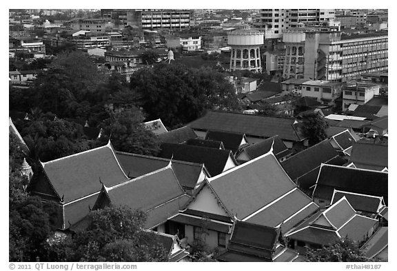 Temple roofs and modern buildings from above. Bangkok, Thailand