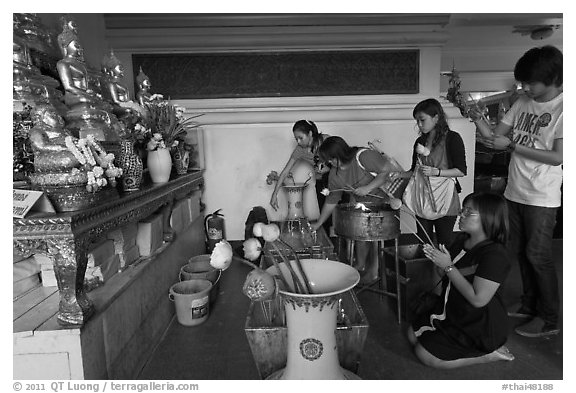 Worshippers with lotus inside Wat Saket. Bangkok, Thailand