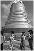 Worshippers circle around chedi. Bangkok, Thailand (black and white)