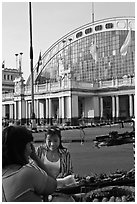 Woman buying food at stall in front of station. Bangkok, Thailand (black and white)