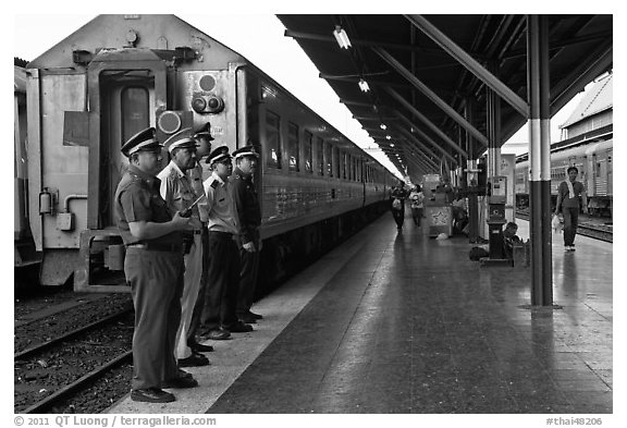 Train platform and attendants. Bangkok, Thailand (black and white)