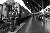 Train platform and attendants. Bangkok, Thailand (black and white)