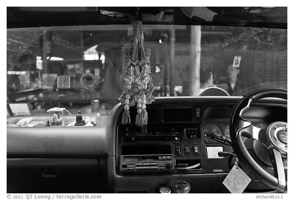 Bus dashboard with religious items. Thailand (black and white)