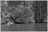 Couple paddling below steep cliffs. Krabi Province, Thailand ( black and white)