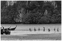 Disembarking at low tide, Rai Leh East. Krabi Province, Thailand (black and white)