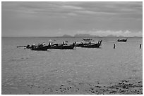 Boats anchored at low tide, storm sky,  Railay East. Krabi Province, Thailand ( black and white)