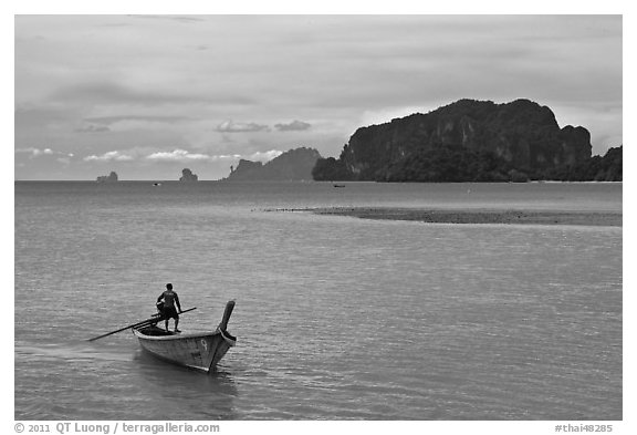 Man driving long tail boat, Ao Nammao. Krabi Province, Thailand (black and white)
