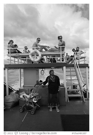 Local woman and tourists on boat, Adaman Sea. Krabi Province, Thailand (black and white)