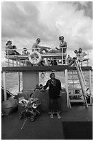 Local woman and tourists on boat, Adaman Sea. Krabi Province, Thailand (black and white)