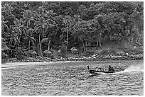 Long tail boat and beach cabins, Ko Phi Phi. Krabi Province, Thailand ( black and white)