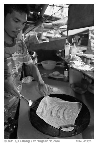 Man preparing thai pancake, Tonsai village, Ko Phi Phi. Krabi Province, Thailand (black and white)