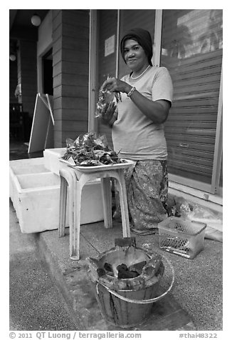 Woman selling grilled seafood, Tonsai village, Ko Phi-Phi island. Krabi Province, Thailand (black and white)