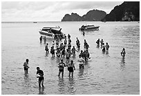 Asian tourists wading in water, Ko Phi Phi. Krabi Province, Thailand (black and white)