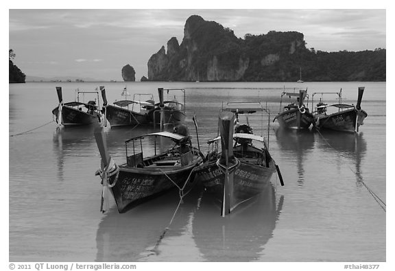 Tranquil waters of Ao Lo Dalam bay with longtail boats, Phi-Phi island. Krabi Province, Thailand (black and white)