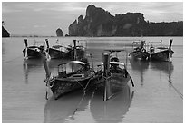 Tranquil waters of Ao Lo Dalam bay with longtail boats, Phi-Phi island. Krabi Province, Thailand ( black and white)