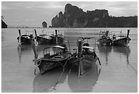 Tranquil waters of Ao Lo Dalam bay with longtail boats, Phi-Phi island. Krabi Province, Thailand (black and white)