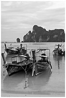 Long tail boats in serene waters of Lo Dalam bay, Ko Phi-Phi island. Krabi Province, Thailand (black and white)