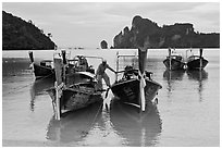 Man stepping on boats, Ao Lo Dalam, Ko Phi-Phi Don. Krabi Province, Thailand (black and white)