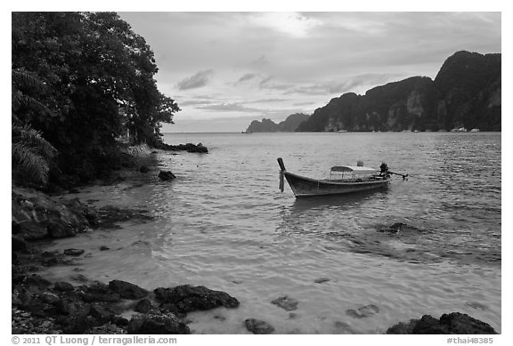Boat, clear water, stormy skies, Phi-Phi island. Krabi Province, Thailand (black and white)