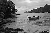Boat, clear water, stormy skies, Phi-Phi island. Krabi Province, Thailand ( black and white)