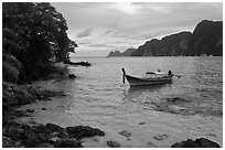 Boat, clear water, stormy skies, Phi-Phi island. Krabi Province, Thailand (black and white)