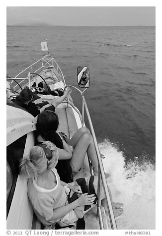 Women sitting on front of boat. Krabi Province, Thailand (black and white)