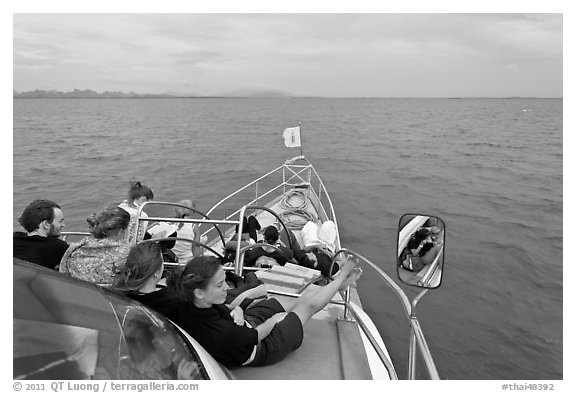 Passengers on prow of boat. Krabi Province, Thailand