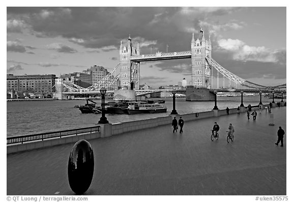 Waterfront promenade in the more London development and Tower Bridge, late afternoon. London, England, United Kingdom (black and white)