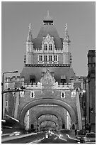 Traffic under arches of the Tower Bridge at twilight. London, England, United Kingdom ( black and white)