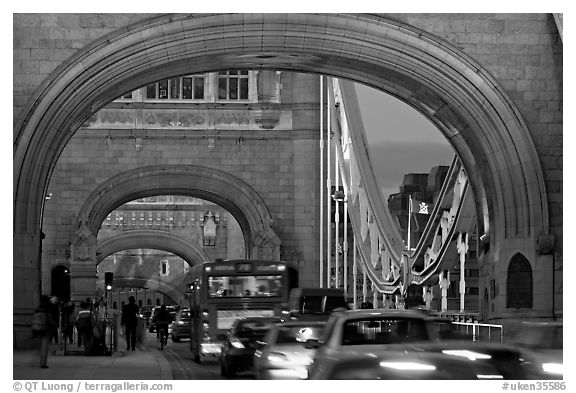 Arches and car traffic on the Tower Bridge at nite. London, England, United Kingdom