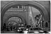 Arches and car traffic on the Tower Bridge at nite. London, England, United Kingdom (black and white)