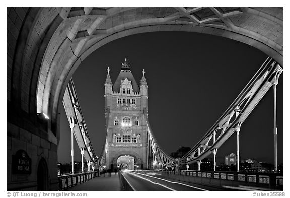 Arch and car traffic on the Tower Bridge at night. London, England, United Kingdom