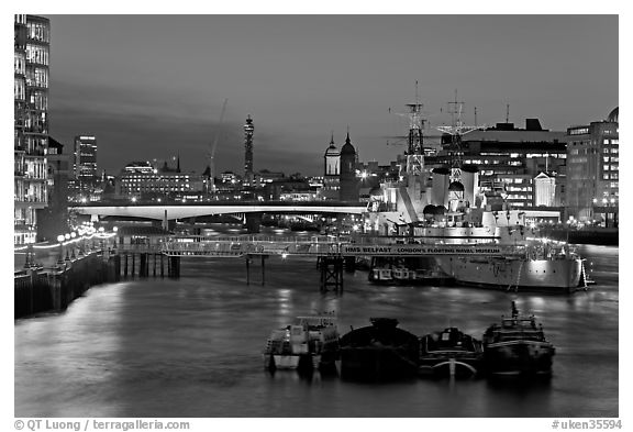 HMS Belfast, London Bridge, and Thames at night. London, England, United Kingdom (black and white)