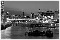 HMS Belfast, London Bridge, and Thames at night. London, England, United Kingdom (black and white)