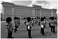 Rows of guards  wearing bearskin hats and red uniforms. London, England, United Kingdom (black and white)