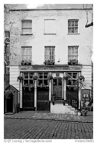 Pub the Grenadier, and cobblestone mews. London, England, United Kingdom (black and white)