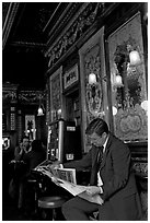 Man reading newspaper in front of etched mirrors, pub Princess Louise. London, England, United Kingdom ( black and white)