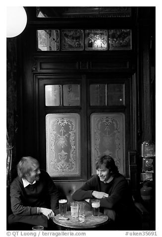 Young men, beer pints, and etched glass, pub Princess Louise. London, England, United Kingdom (black and white)
