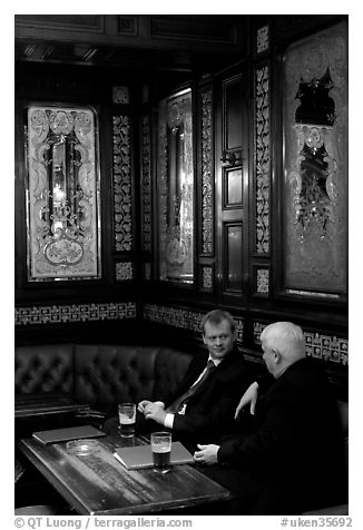 Business men talking over a beer, Victorian boozer Princess Louise. London, England, United Kingdom